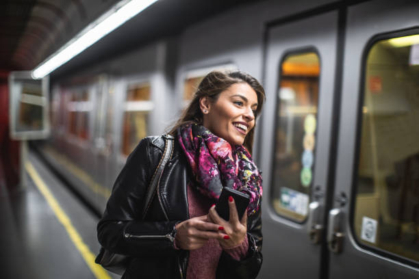 istock Young woman waiting train at subway station 1180293185