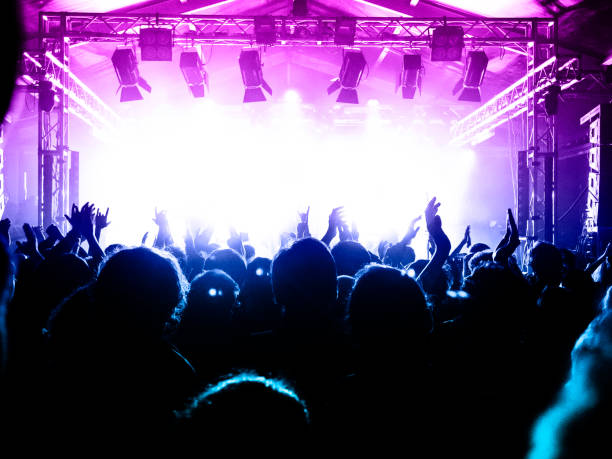 Live music crowd Concert spectators in front of a bright stage with live music popular music concert photos stock pictures, royalty-free photos & images