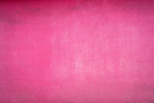 A cloudy pink and white wall has a faded look to it.