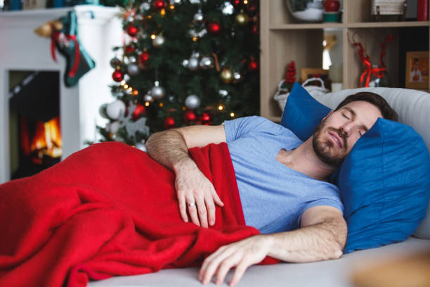 istock Man sleeping in cozy bed, covered with a warm blanket 1180307842