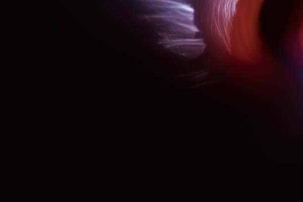 istock red purple light strokes black abstract background 1180307879