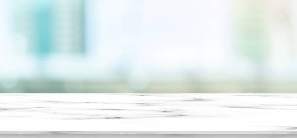 istock abstract blur city landscape view form high zone hotel window with white marble effect texture counter perspective for show ,promote content and ads banner design concept 1180308097