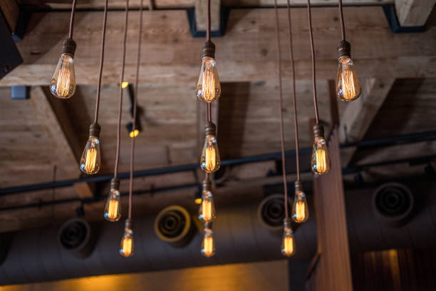 istock Old Fashion Style Lightbulbs Hanging From The Ceiling On Long Wires 1180308149