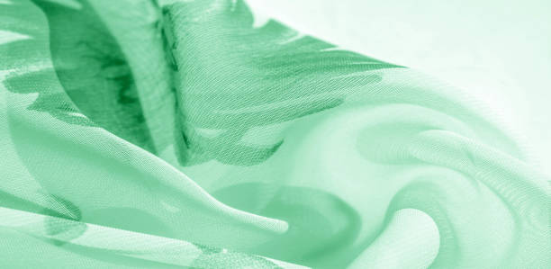 istock Texture background, pattern, wallpaper. white silk fabric, green print. This silk lightweight fabric with a print is perfect for your projects, Internet decor. Colors include beige green and red. 1180308327