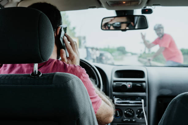 istock man driving a car talking on the phone, accident.crosswalk 1180308393