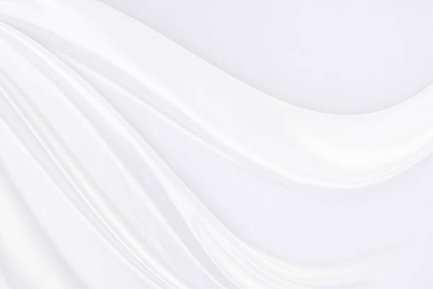 istock White fabric texture that is white silk background with beautiful soft blur pattern. 1180316344