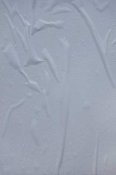 istock air pockets, wrinkled uneven white glued poster paper background effect 1180319122