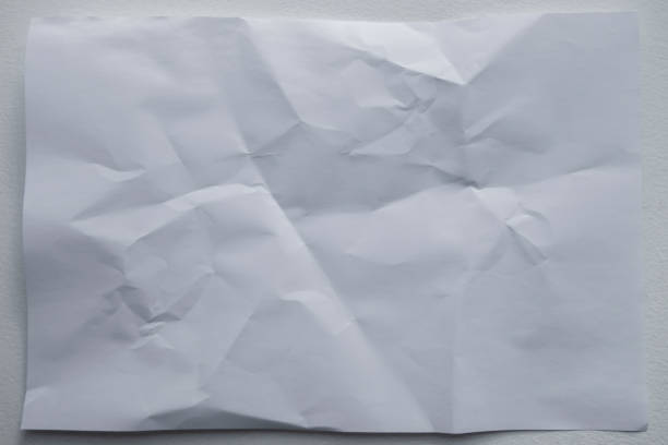 istock wrinkled crumbled up uneven white paper background 1180319124