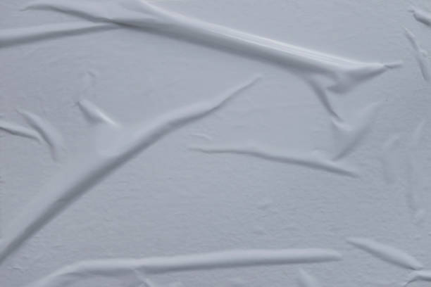 istock air pockets, wrinkled uneven white glued poster paper background effect 1180319129