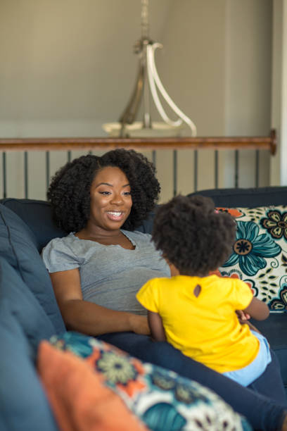 istock African American mother playing and talking with her daughter. 1180331437