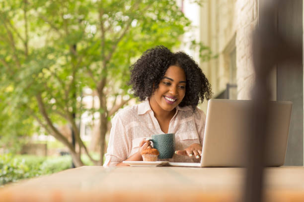 istock African American woman working and drinking coffee. 1180333877