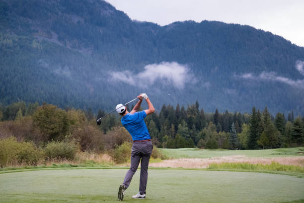 istock Male golfer hitting the perfect tee shot 1180337895
