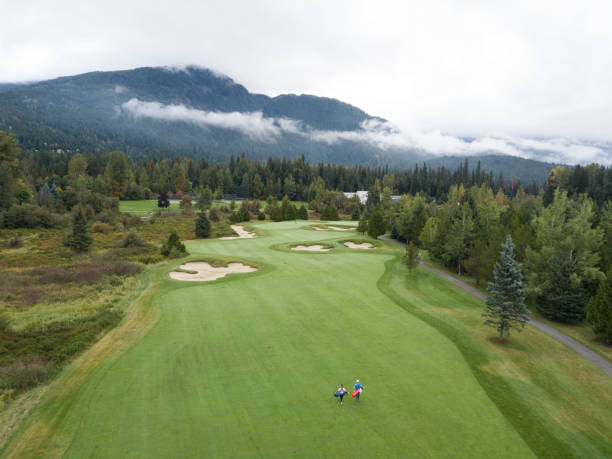 Golfers walking down the fairway