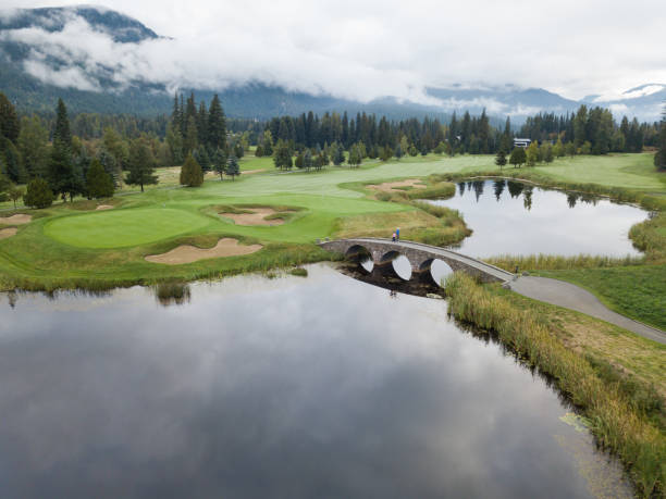istock Golfers cross the bridge towards the putting green 1180339936
