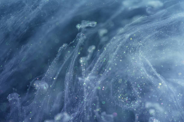 istock Acrylic ink with glitter floating in the water 1180342170