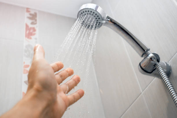 istock water from the shower checking the water selective focus 1180342237
