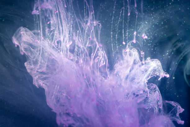istock Pink ink in the water isolated on black background 1180342323