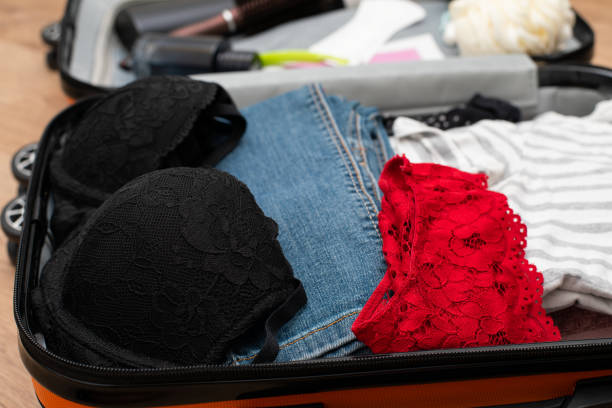 Traveler suitcase full of clothes at cozy modern apartment