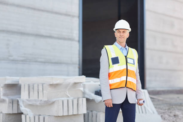istock Mature construction engineer wearing a safety vest on his worksite 1180348752