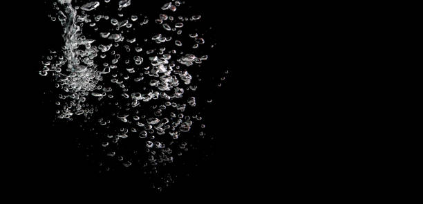 istock water splash with bubbles of air, isolated on a black background. 1180349469