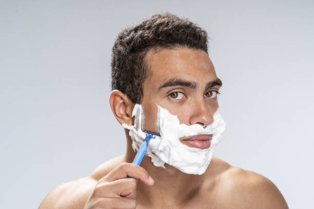 istock Calm young man shaving in the morning 1180353122