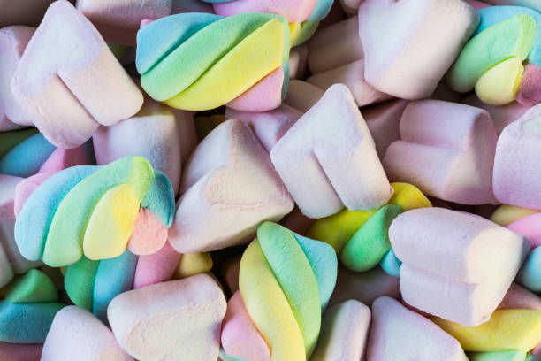 istock Multi-colored Marshmallow twist and heart background. Copy space background and texture 1180355443