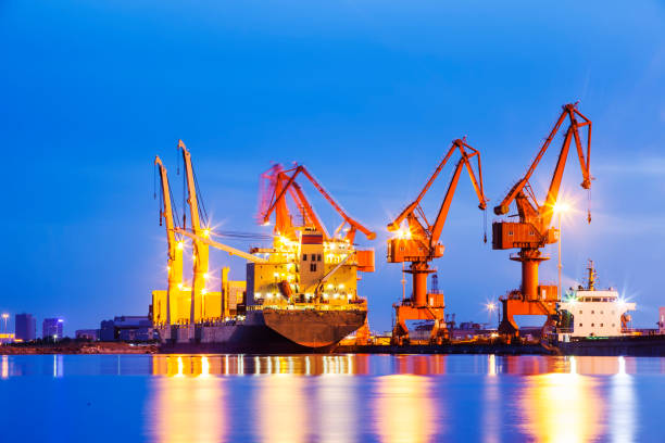 istock Gantry crane and cargo ship in the evening, Shipping and logistic concept 1180355614