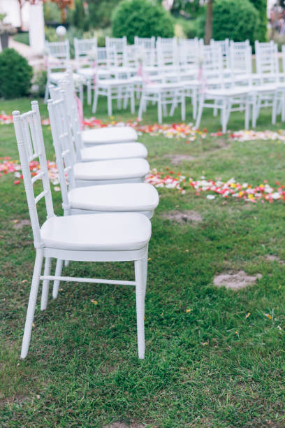 istock wedding or ceremony set up in garden, white chairs 1180363403