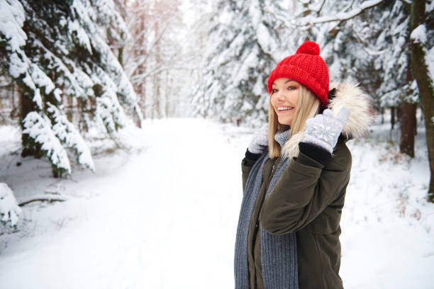 istock Smiling woman in winter forest 1180368106