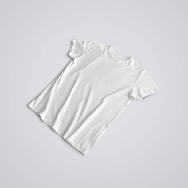 istock Unfolded  blank T-shirt  with shadows  lying on the studio background. 1180368109