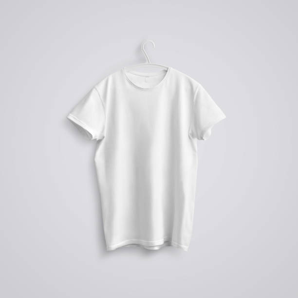 istock A blank T-shirt with shadows on a white plastic hanger  on a studio background. 1180368132