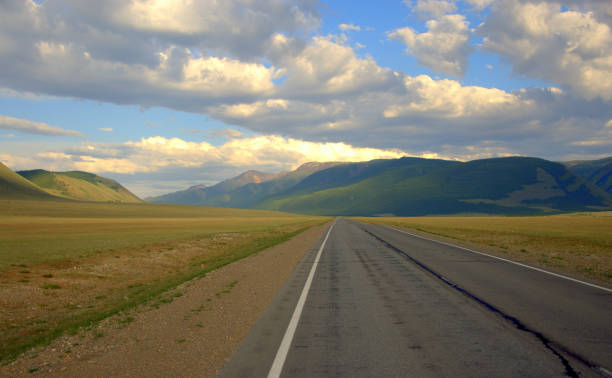istock A direct asphalt road running through the valley rests on the mountains. 1180370627