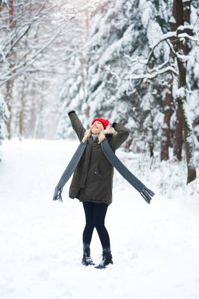 istock Joyful woman dancing in winter forest 1180371968