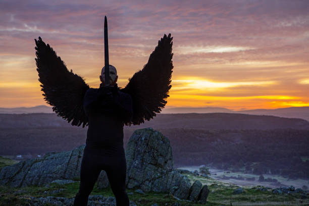 istock Black Winged Warrior Angel at dawn 1180374668
