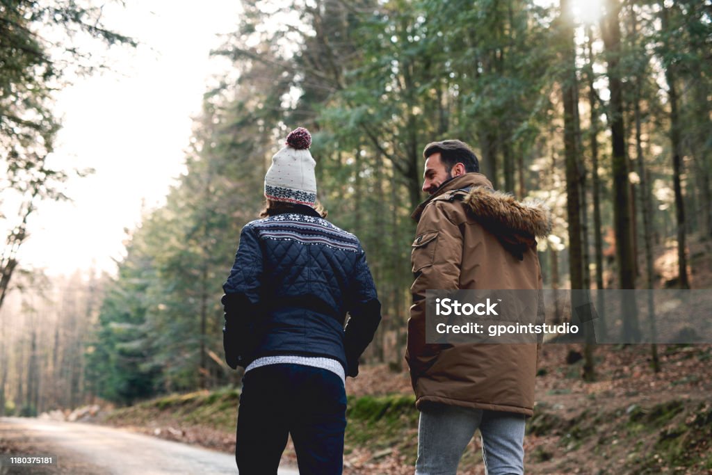 Rear view of father and son walking in autumn forest Walking Stock Photo