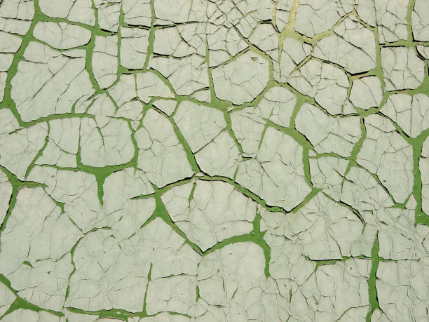 istock Green cement wall with cracked paint. Abstract grunge texture background. Copy space, empty template for text 1180377543