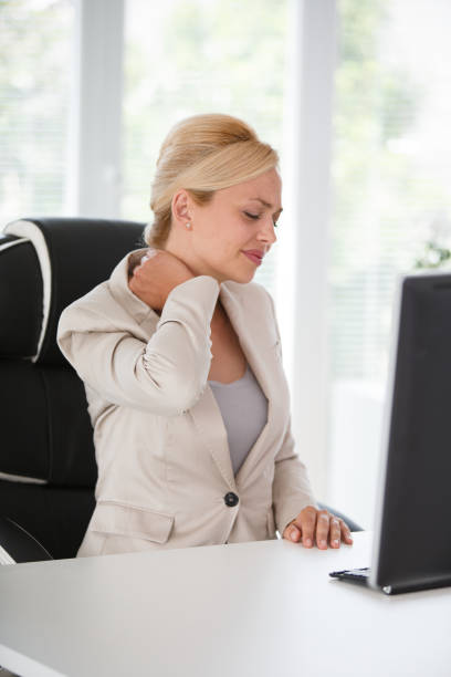 istock Secretary experiencing neck pain at work 1180378529