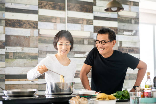 istock Chinese couple cooking in the kitchen 1180381160