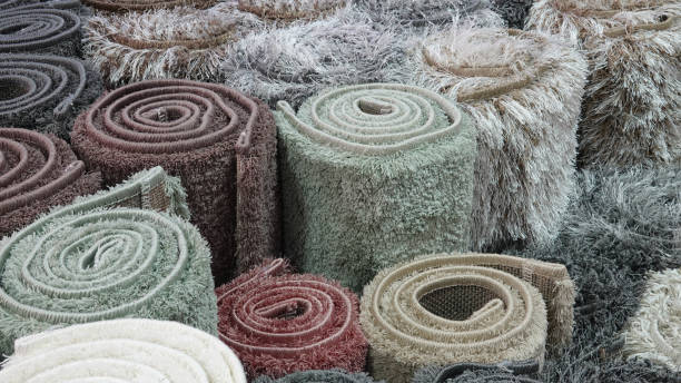 istock Carpets variety selection rolled up rugs shop store 1180381642