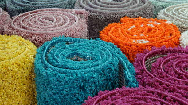 istock Carpets variety selection rolled up rugs shop store 1180381828