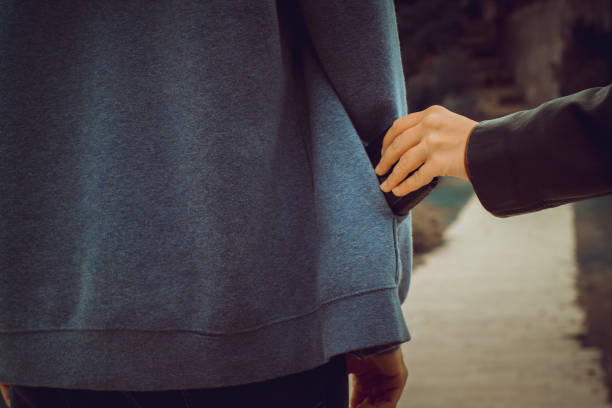 istock Pickpocket a purse from a hoodie at a park 1180382576