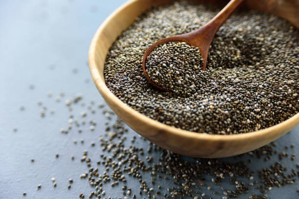 istock Chia seeds in old wooden bowl 1180383485