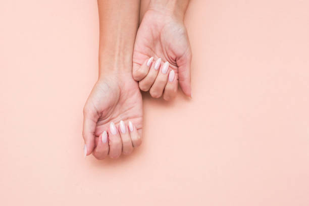 istock Stylish trendy female manicure. Beautiful woman's hands on soft background. 1180384407