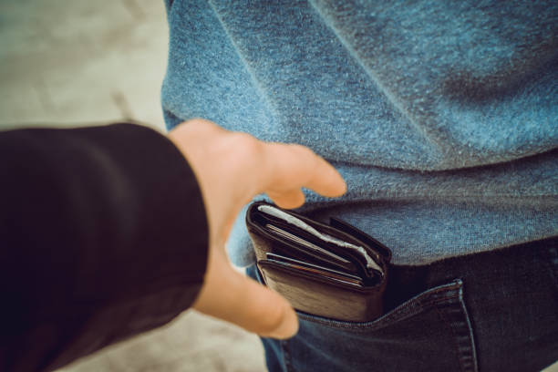 Stealing wallet from the back pocket one hand reaches for a purse in the back pocket pickpocketing stock pictures, royalty-free photos & images