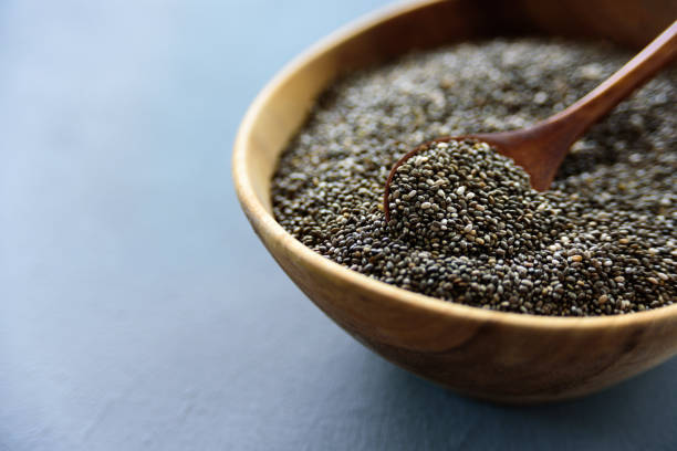istock Chia seeds in old wooden bowl 1180384897