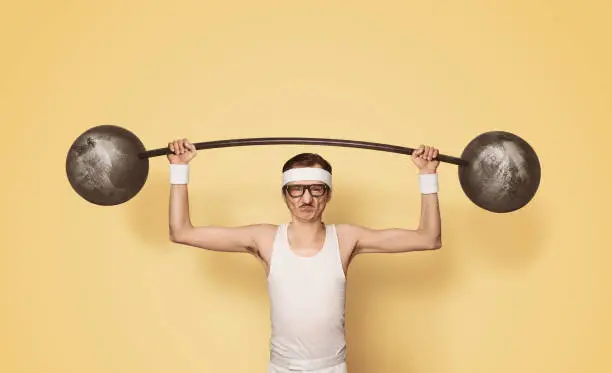 Photo of Funny retro sport nerd lifting weights