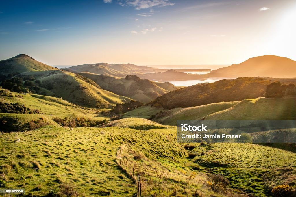 Views across Otago Peninsula, Harbour Cone and Hoopers Inlet at sunrise New Zealand Stock Photo