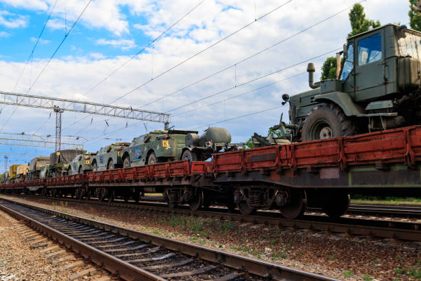 istock Cargo train carrying military vehicles on railway flat wagons 1180390499