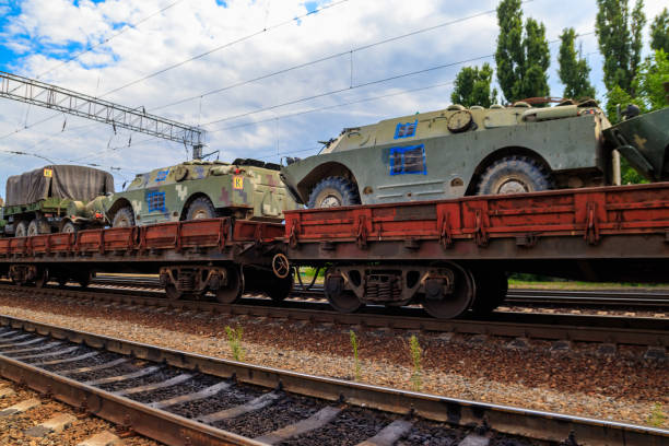istock Cargo train carrying military vehicles on railway flat wagons 1180390501
