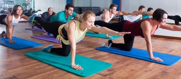 istock People relaxing and enjoying yoga 1180392954